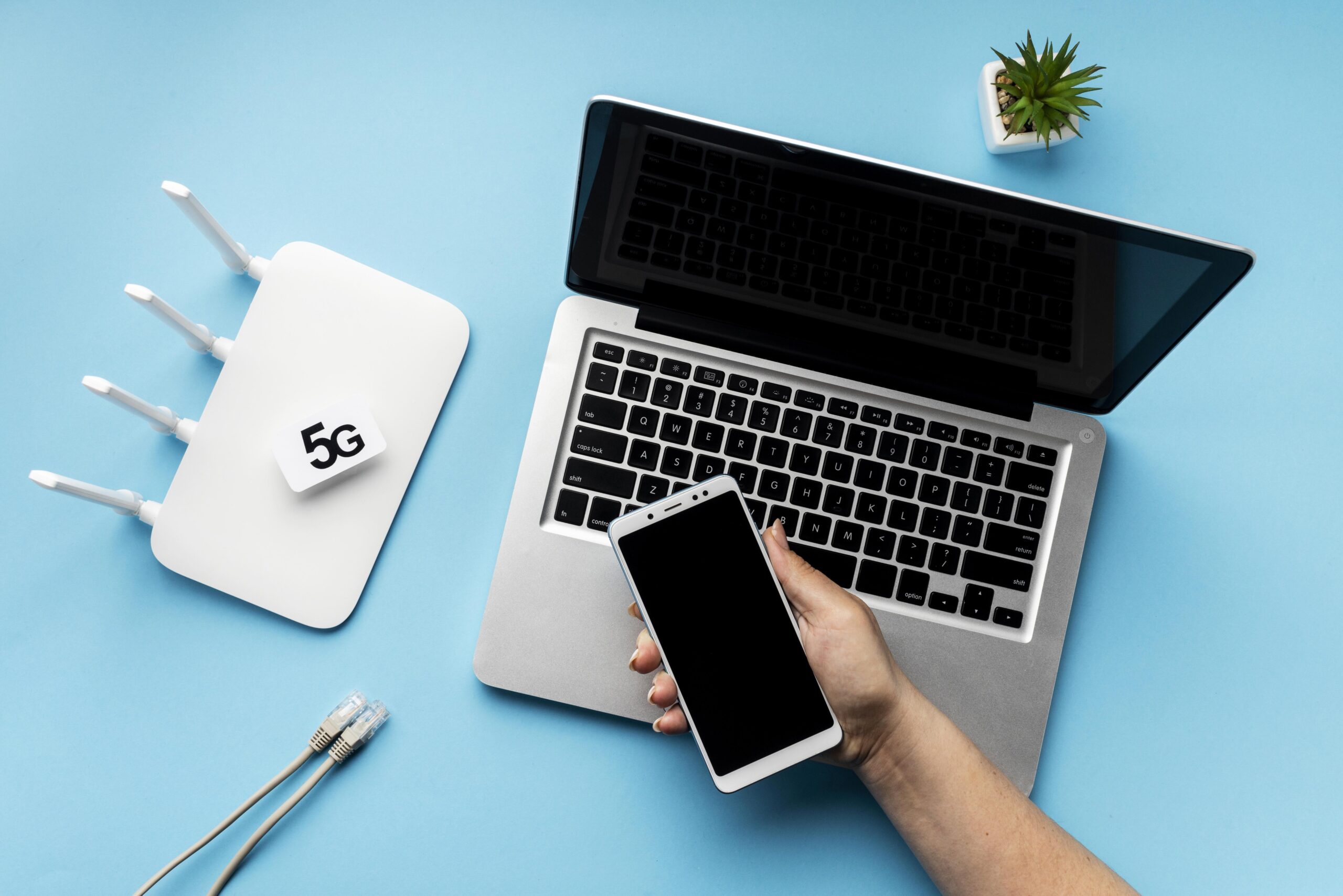 top-view-wi-fi-router-with-laptop-hand-holding-smartphone